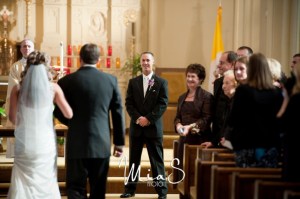 groom-and-family-smiling-as-they-watch-bride-walk-down-wedding-ceremony-aisle-1024x680(pp_w854_h567)